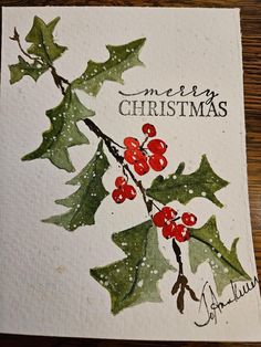 a christmas card with holly leaves and berries