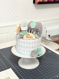 a baby shower cake sitting on top of a table