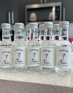 six bottles of gin fizz sit on a counter