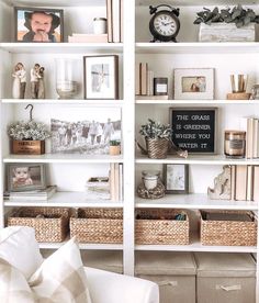 a white book shelf filled with lots of books and other items on top of it