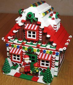 a lego christmas house on a wooden table