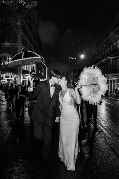 a man and woman walking down the street at night