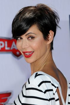 a woman with short black hair and red lipstick