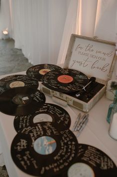 an assortment of records are on display at a wedding reception with the guests'names and date written on them