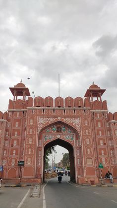 a large red brick building with an arched doorway and arches on the side of it