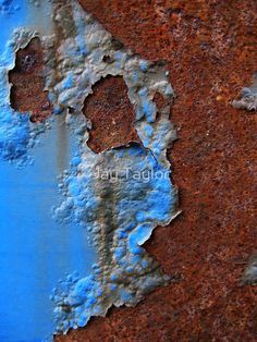 an old rusted metal surface with blue paint