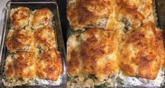 four baking pans filled with food sitting on top of a stove covered in grease