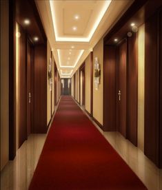 a long hallway with red carpet and lights on either side, leading to another room