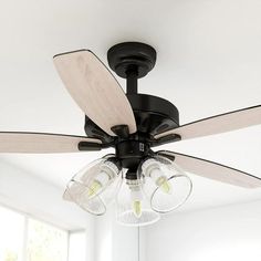 a ceiling fan with three light bulbs hanging from it's blades in a white room