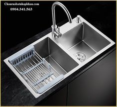 a stainless steel kitchen sink with two faucets on the left and right sides