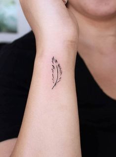 a woman's arm with a small tattoo on the left side of her wrist