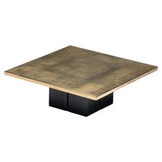 a square wooden table with black legs and an aged finish on the top, against a white background