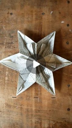 an origami flower on a wooden table