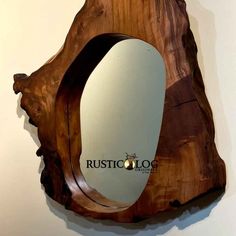 a wooden mirror hanging on the wall next to a white wall with words rusticoloo