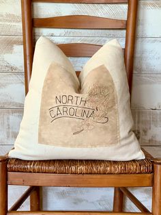 the north carolina pillow is sitting on a chair