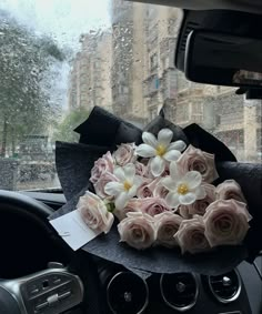 a bouquet of flowers sitting on the dashboard of a car