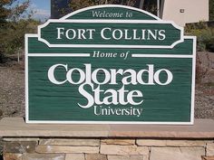 a welcome sign for fort collinss home of the colorado state university