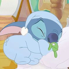 a cartoon character sleeping on top of a bed with a stuffed animal in it's mouth