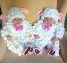 two babies dressed in sheep costumes sitting next to each other