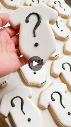 someone is decorating cookies with question marks on them