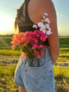 a woman holding flowers in her back pocket