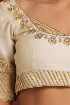 Cream saree blouse with gota patti trims and zardozi embroidery.
Component: 1
Pattern: Embroidery
Type Of Work: Gota Patti
Neckline: Scoop
Sleeve Type: Half
Fabric: Chanderi Tissue
Color: Cream
Other Details: 
Panels at the neckline
Closure: Side zip
Note: Saree worn by the model is not for sale
Occasion: Wedding - Aza Fashions Cream Saree, Saree Blouses Online, Zardozi Embroidery, Cream Blouse, Pattern Embroidery, Blouse For Women, Work Sarees, Blouse Online, Work Blouse