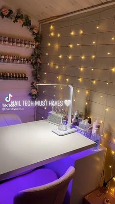 a white counter top sitting next to a wall covered in bottles and lights on it