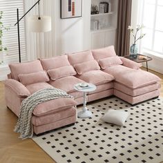 a living room with a pink sectional couch