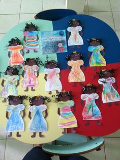 a child's artwork project with paper dolls on it