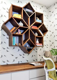 an office with a desk and shelves filled with birds on the wall, along with a chair