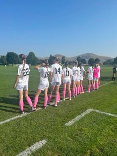 the girls soccer team is lined up on the field