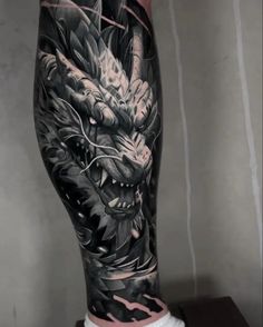 a man's leg with a dragon tattoo on it