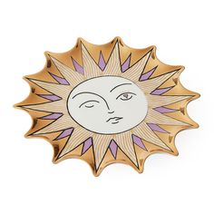 the sun brooch is shown in gold and purple