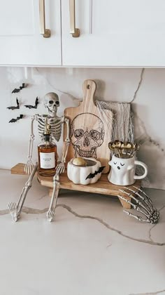 halloween decorations on a kitchen counter with skeleton figurines