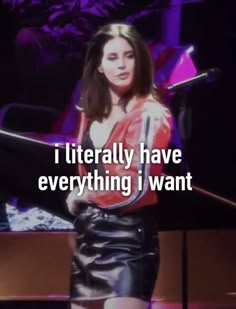 a woman standing in front of a microphone with the words i literally have everything i want