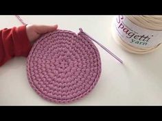 someone is crocheting a round with yarn