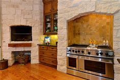 a kitchen with an oven, stove and counter space in it's center area