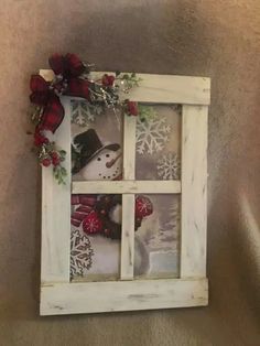 an old window is decorated with snowmen and wreaths