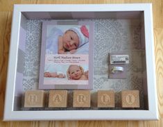 a baby's photo in a frame with wooden blocks