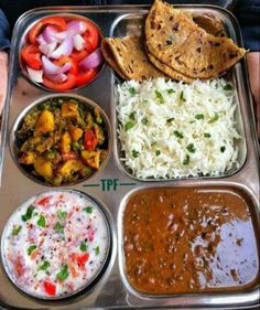 a metal tray filled with different types of food