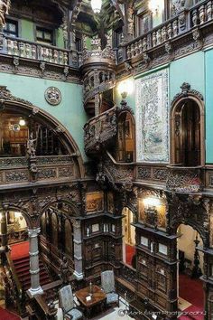 the inside of an ornate building with many windows and balconies on each floor