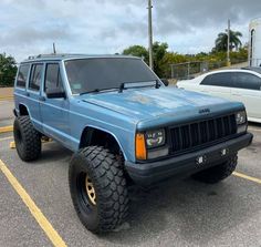 a blue jeep parked in a parking lot