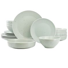 a stack of white dishes sitting next to each other