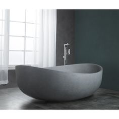 a bathtub sitting on top of a tiled floor next to a window