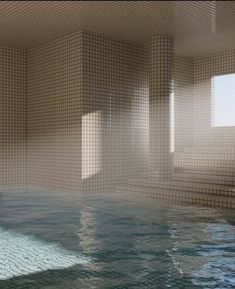 an indoor swimming pool with tiled walls and water in the foreground, surrounded by stone steps