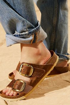 **Fit:** Narrow: A-B Width Classic two-strap style Birkenstock featuring large statement buckles and a distressed look. Genuine leather straps are featured with comfortable, lightweight sole. * Anatomically shaped cork-latex footbed A Birkenstock narrow width fit is comparable to a Medium (B Width). | Arizona Big Buckle Birkenstock Sandals at Free People in Brown, Size: EU 36 Birkenstock Big Buckle Outfit, Birkenstock Street Style, Big Buckle Birkenstock, Brown Birkenstocks, Birkenstock Big Buckle, Arizona Big Buckle, Birkenstock Styles, Birkenstock Outfit, Birkenstock Style