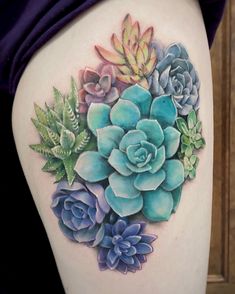 a woman's thigh with succulents and leaves on it