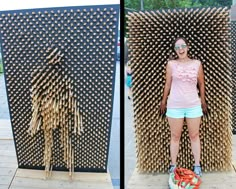 a woman standing in front of a sculpture made out of wooden sticks and straws