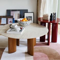 a bowl of oranges sitting on top of a table