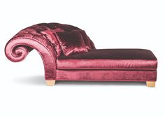 a pink velvet chaise lounge chair with pillows